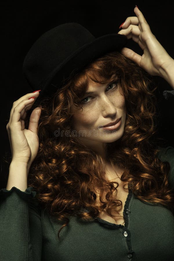 Pretty SMILING red-haired girl with curls, black hat