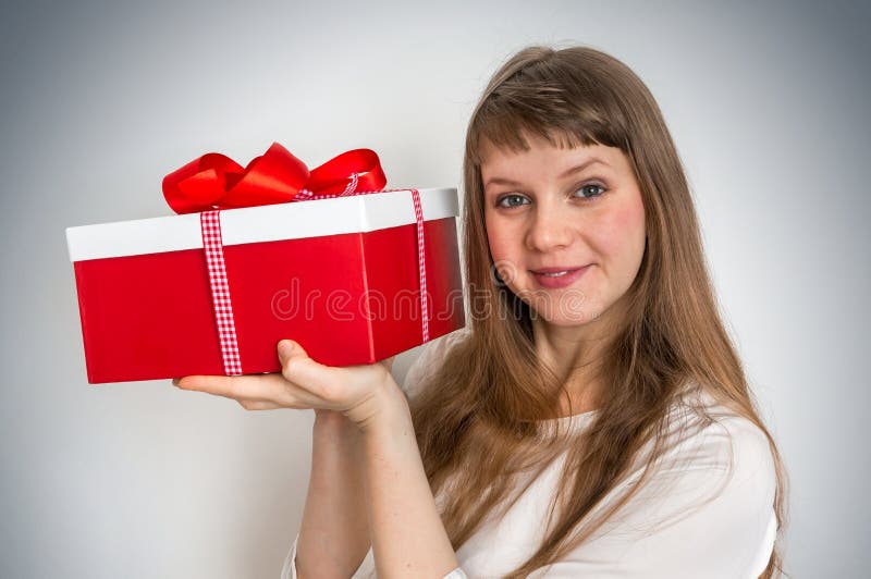 Pretty smiling woman with red gift box stock photo Pretty smiling woman with red gift box stock photo