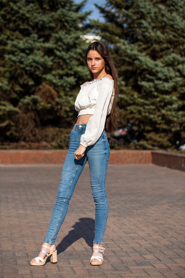 Pretty Stylish Brunette Girl in Blue Jeans and White Blouse Stock Image ...