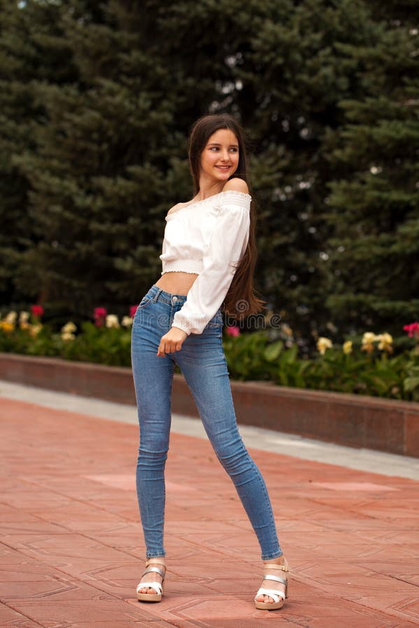 Pretty Stylish Brunette Girl In Blue Jeans And White Blouse Stock Image ...