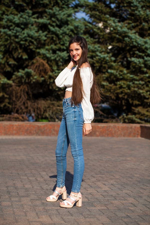 Pretty Stylish Brunette Girl in Blue Jeans and White Blouse Stock Image ...