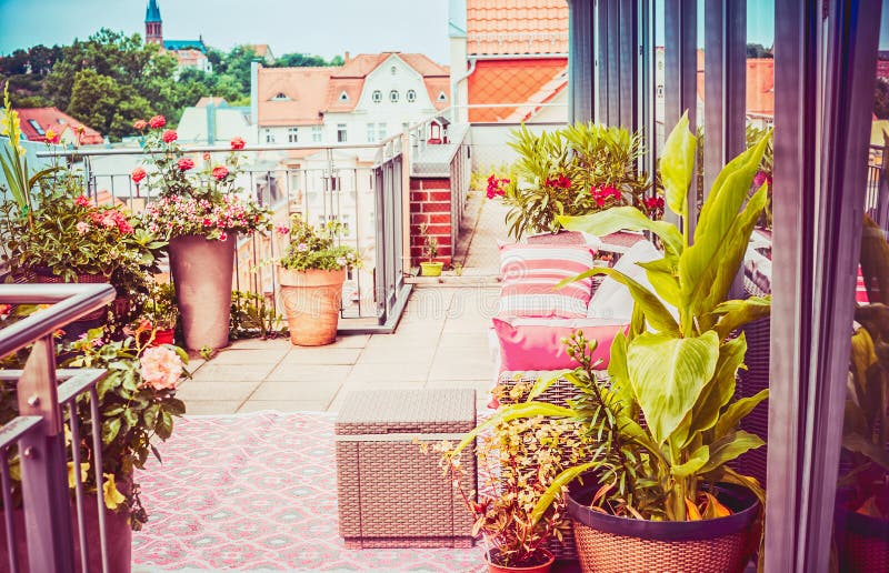 Pretty summer terrace or balcony of penthouse with flowers patio pots