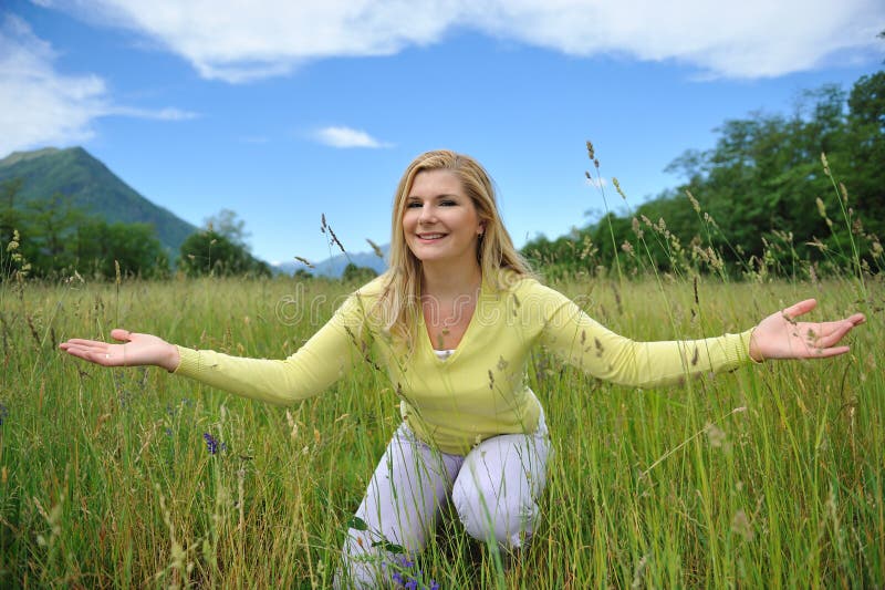 Pretty summer woman outdoors on green field