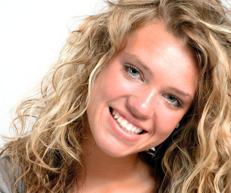 Pretty teen girl closeup, with a big smile. The girl has long blond curly hair. Pretty teen girl closeup, with a big smile. The girl has long blond curly hair.