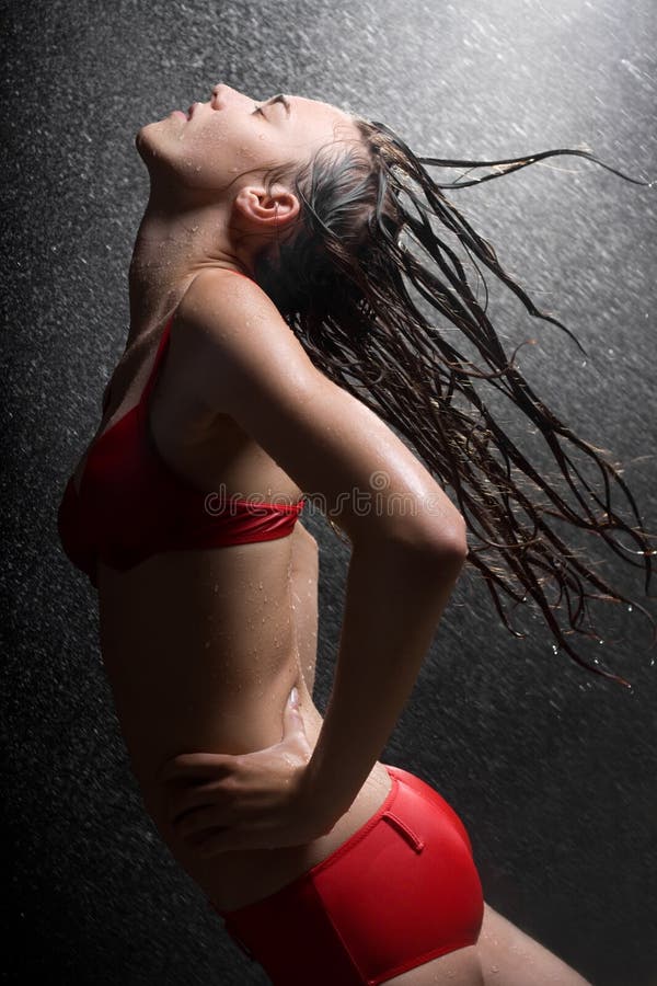 Pretty teen girl in water studio