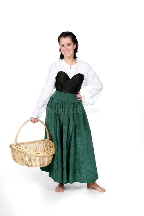 Pretty teenage girl in period dress holding basket