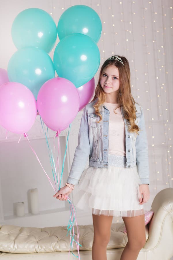 Pretty teenager girl with many blue and pink balloons stock image Pretty teenager girl with many blue and pink balloons stock image