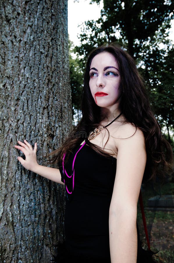 Pretty vampire near tree royalty free stock images Pretty vampire near tree royalty free stock images