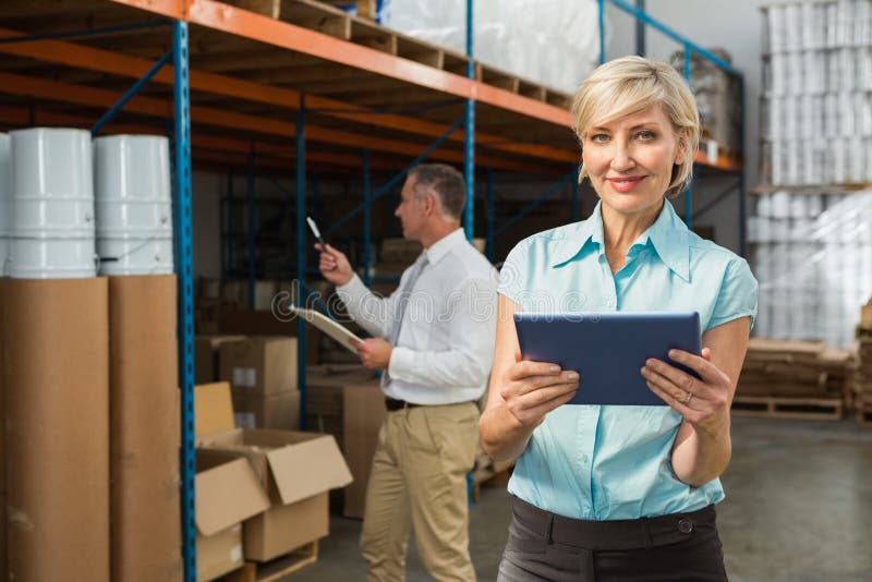 Pretty warehouse manager using tablet pc royalty free stock images