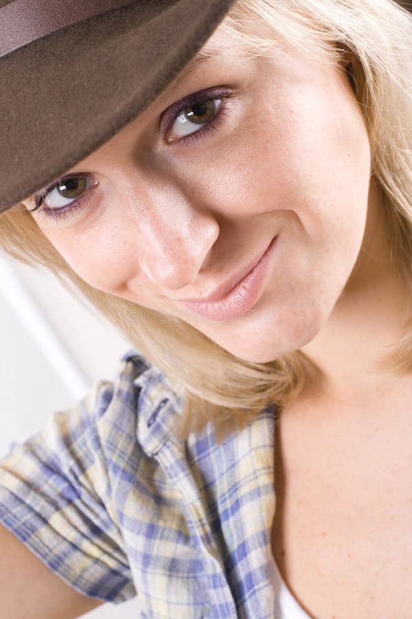 Pretty western woman in cowboy shirt and hat