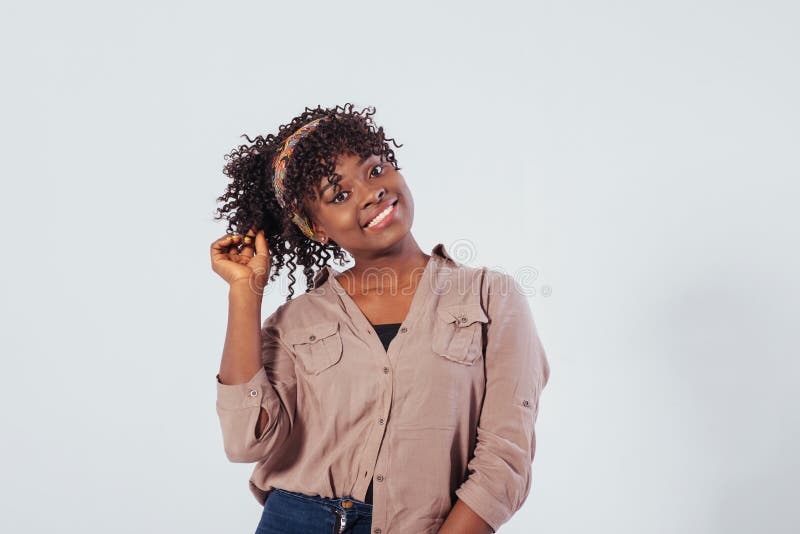 Pretty woman. Beautiful afro american girl with curly hair in the studio with white background