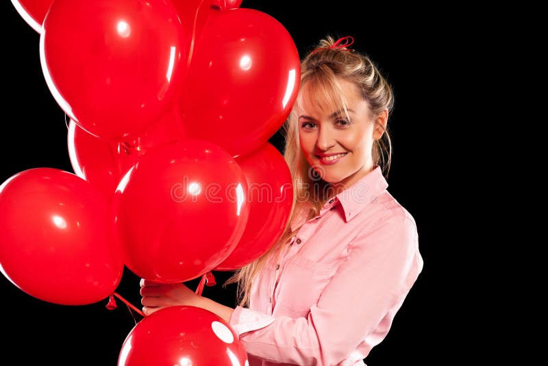 Pretty woman in blouse with red balloons