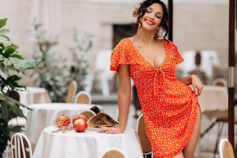 Pretty woman with candid smile laughing sitting at summer cafe, dressed in white printed dress, fashionable street style royalty free stock photo Pretty woman with candid smile laughing sitting at summer cafe, dressed in white printed dress, fashionable street style royalty free stock photo