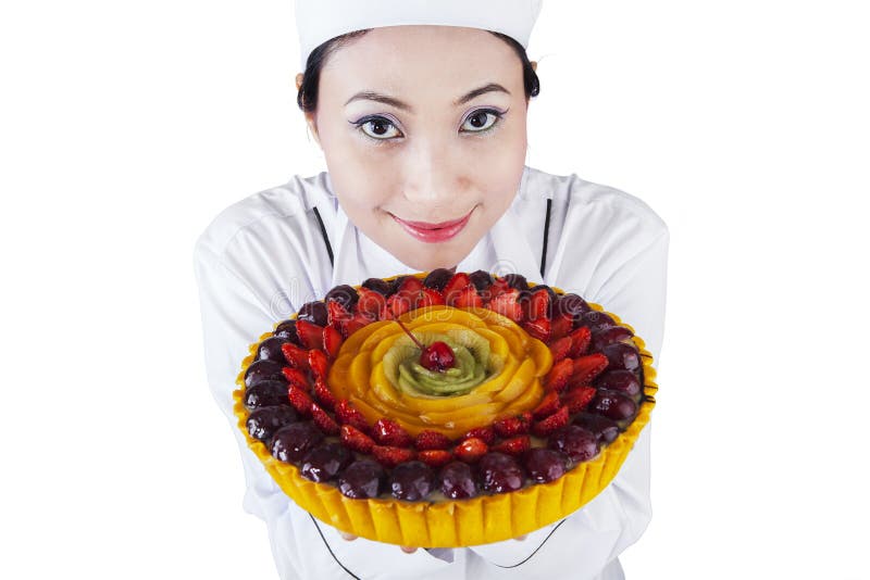Pretty woman chef holding a dessert cake royalty free stock photo Pretty woman chef holding a dessert cake royalty free stock photo