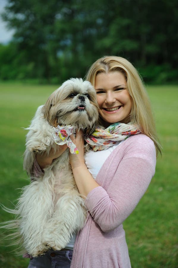 Pretty woman with cute shih tzu dog outdoors