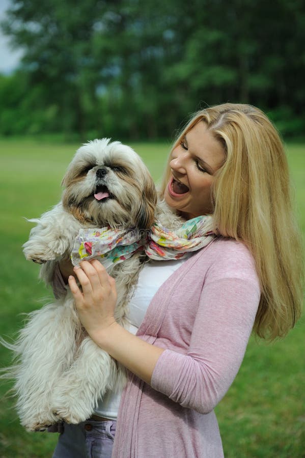 Pretty woman with cute shih tzu dog outdoors