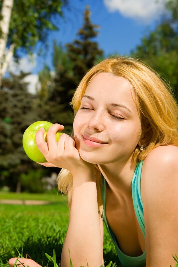 Pretty woman eating green apple