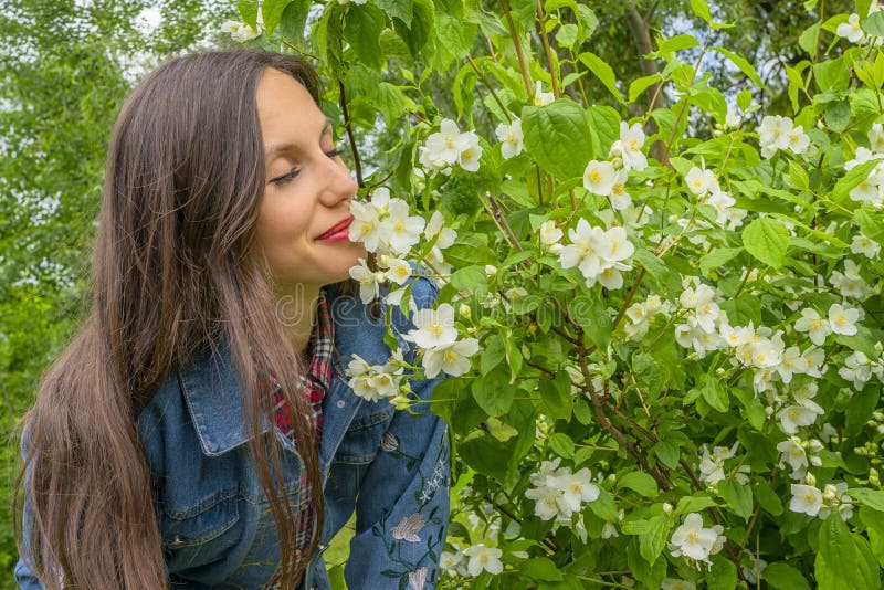 pretty-woman-enjoy-jasmine-spring-flowers-portrait-girl-plant-garden-womens-day-207720367.jpg