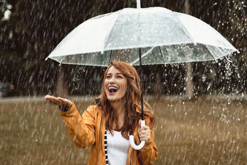 Pretty woman feeling excited about rainy weather