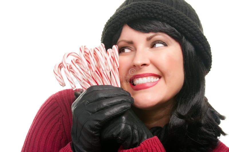 Pretty Woman Holding Candy Canes Isolated on a White Background.