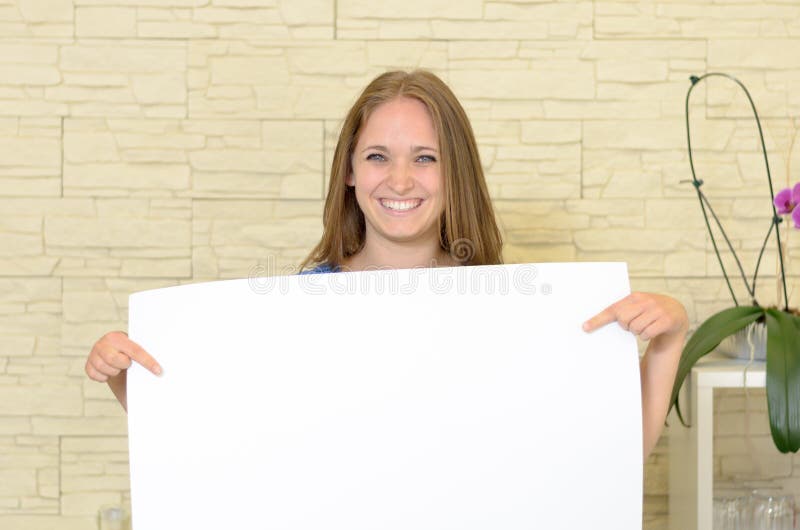 Pretty woman holding up a blank white sign