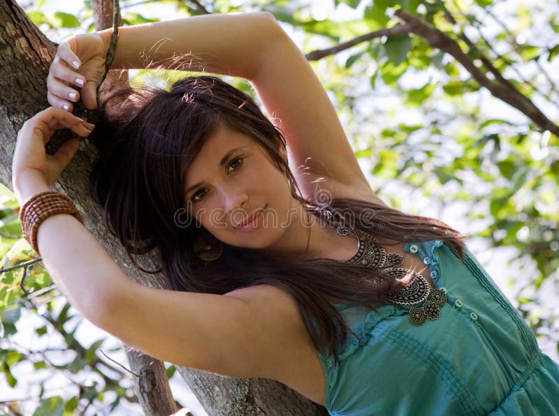 Pretty Woman Leaning Against Tree