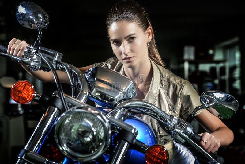 Pretty woman on motorcycle at night