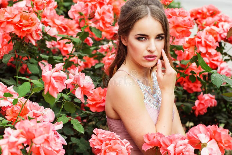 Pretty Woman Near Bush of Pink Roses Outdoors Stock Photo - Image of ...