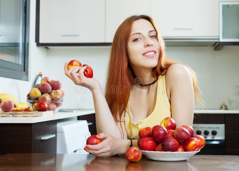 Pretty woman with nectarines stock images