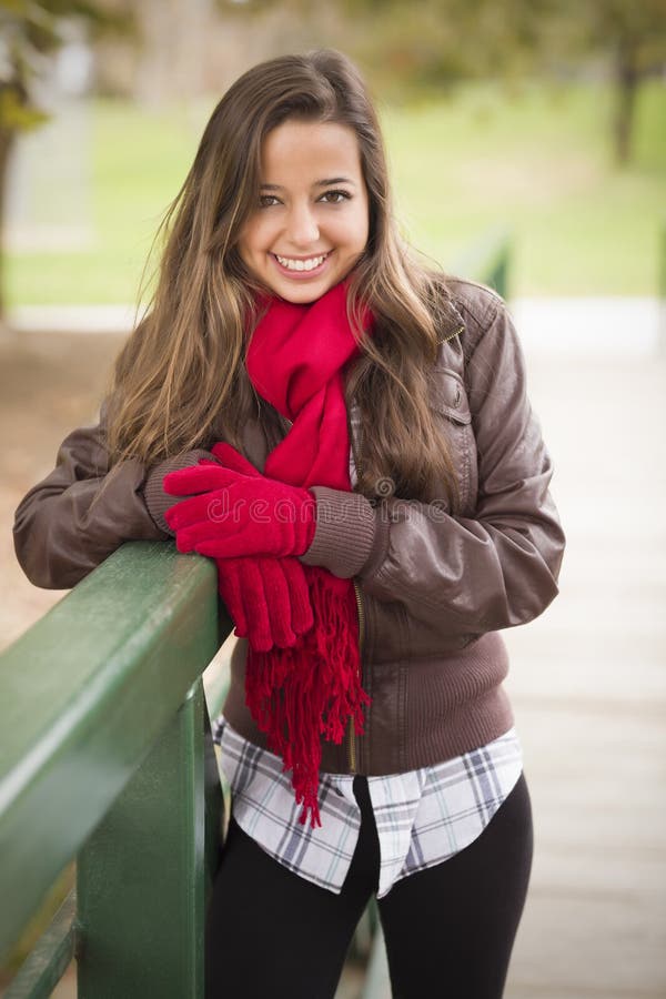 Pretty Woman Portrait Wearing Red Scarf and Mittens Outside