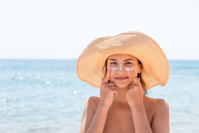Pretty Woman Protects Her Skin on Face with Sunblock at the Beach Stock ...