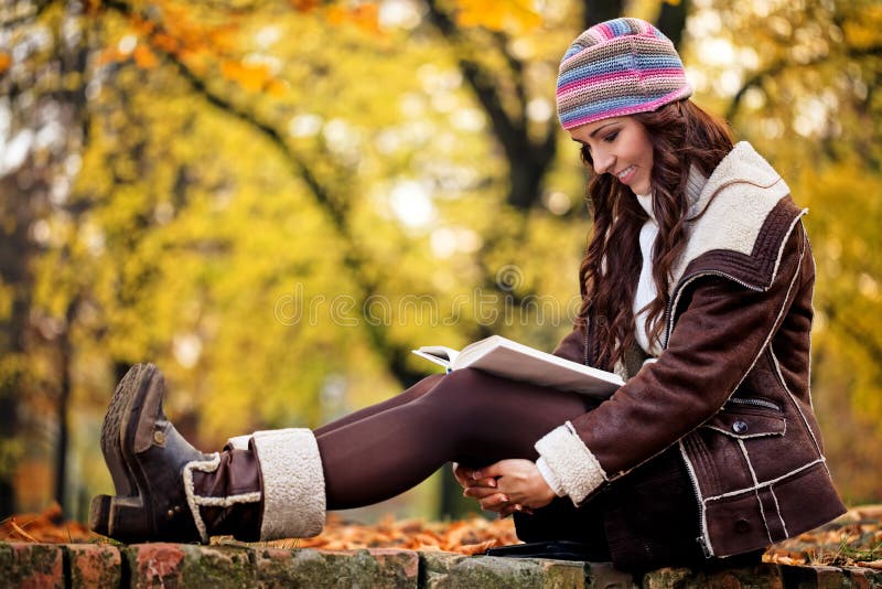 Pretty woman reading book and smiling