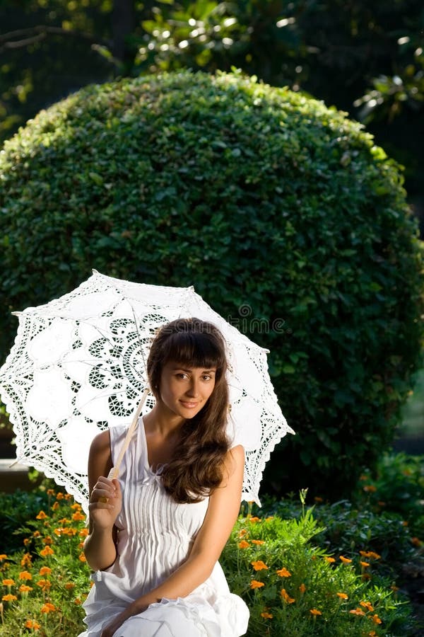 Pretty woman with sun umbrella