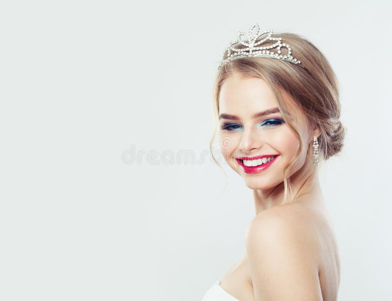 Pretty woman with wedding hairstyle and diamonds jewelry. Smiling model girl portrait royalty free stock image Pretty woman with wedding hairstyle and diamonds jewelry. Smiling model girl portrait royalty free stock image