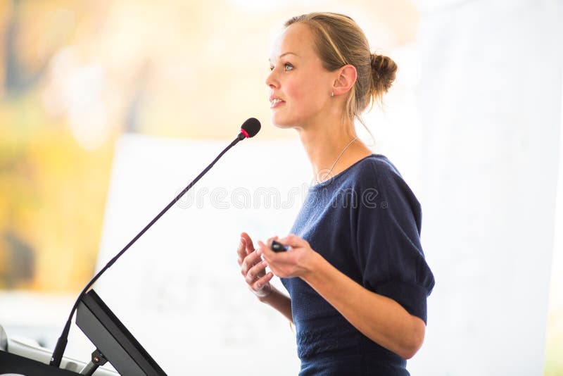 Pretty, young business woman giving a presentation