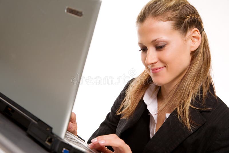 Pretty young businesswoman working with laptop