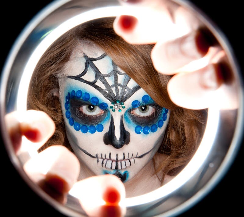 Pretty young female in sugar skull make up