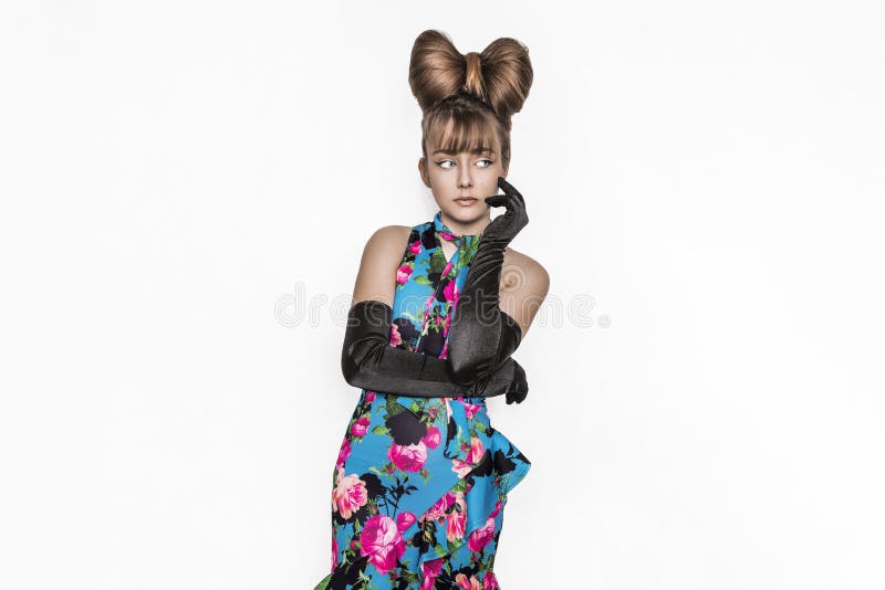 Pretty young girl beauty portrait. Elegant Fashion Glamorous teen Model wearing black Glamour Gloves and floral dress. Bow