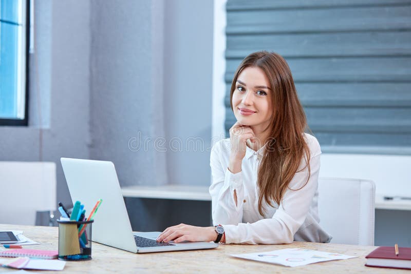 A Girl Office Worker, Sitting at Table with Laptop and Smiling. Stock Photo  - Image of corporate, businessman: 106665706