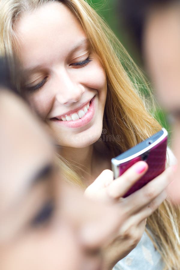 Pretty young girl chatting with smartphone