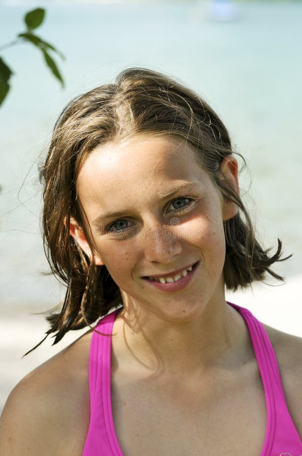 Pretty young girl in pink by the water