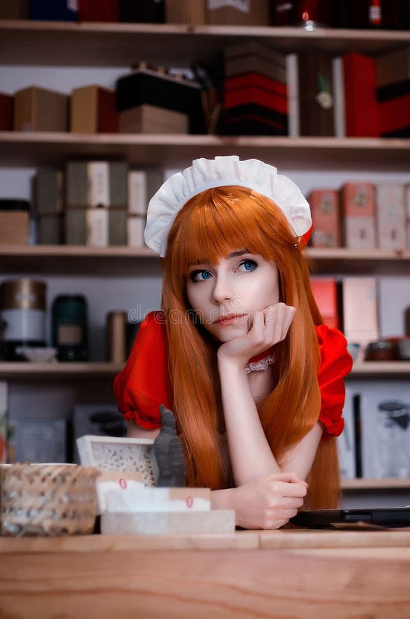 Pretty young girl servant costume portrait dressed in red in the shop