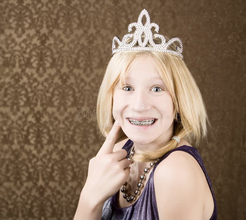 Pretty young girl with a tiara with braces