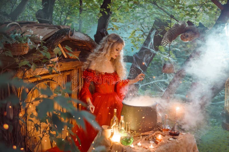 Pretty young lady with blond curly hair above big magic cauldron with smoke and bottles with liquids, forest nymph in