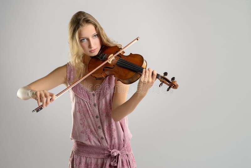 Pretty young violinist playing the violin