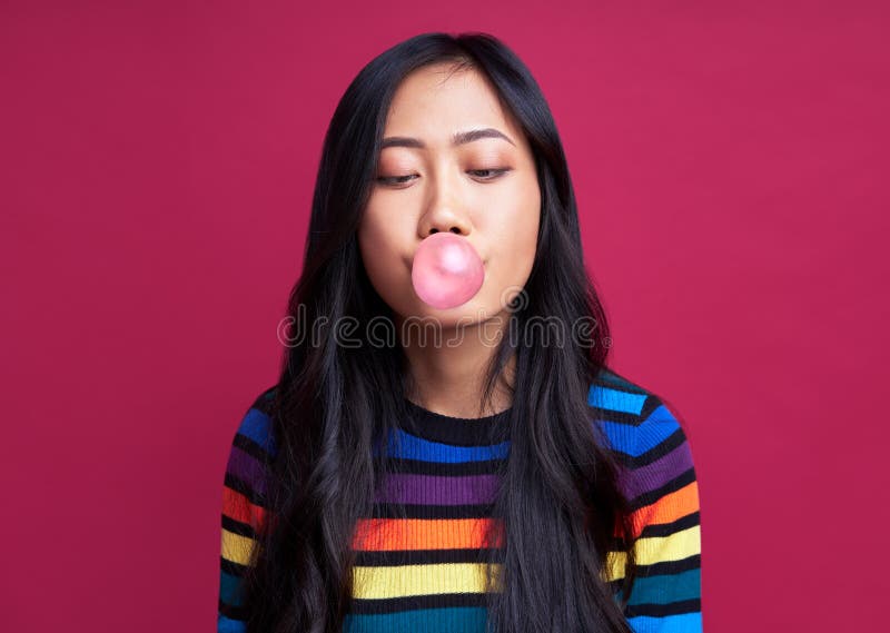 Pretty young woman blowing bubble with chewing gum stock photography Pretty young woman blowing bubble with chewing gum stock photography