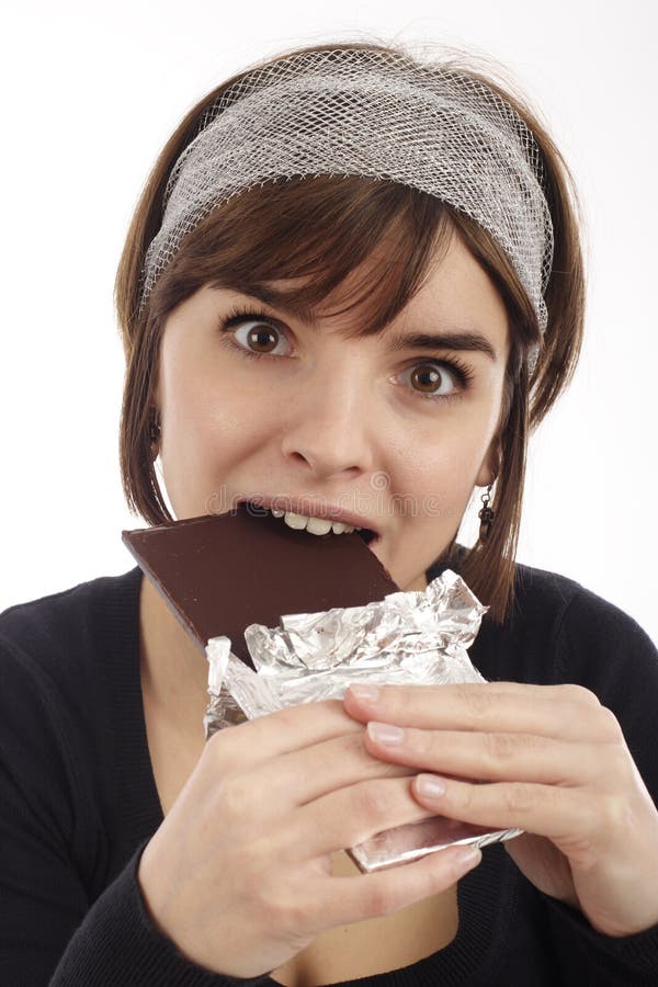 Pretty young woman eating chocolate