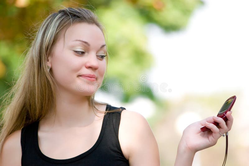 Pretty young woman holding mobile phone