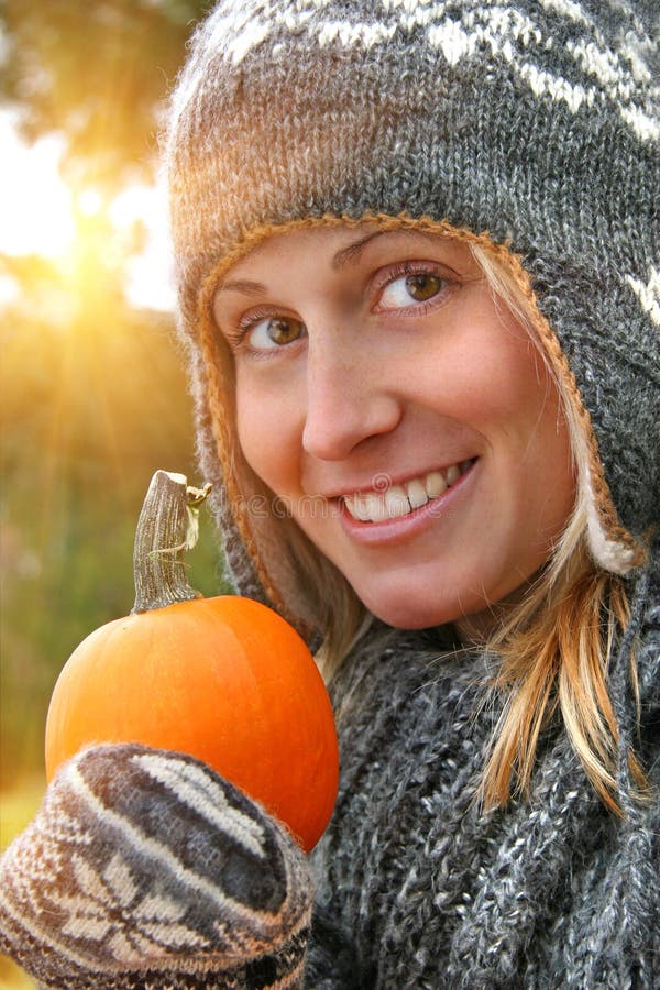 Pretty young woman holding a pumpkin royalty free stock image Pretty young woman holding a pumpkin royalty free stock image