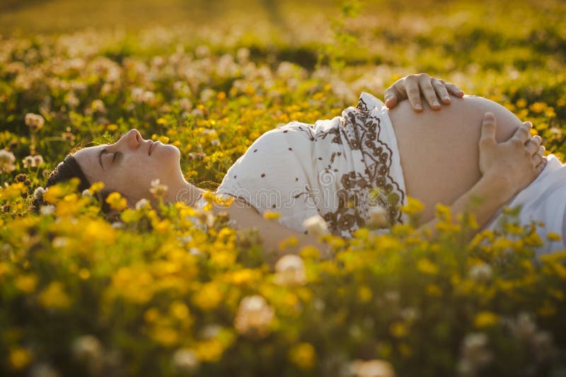 Pretty young woman pregnant lying down stock images Pretty young woman pregnant lying down stock images
